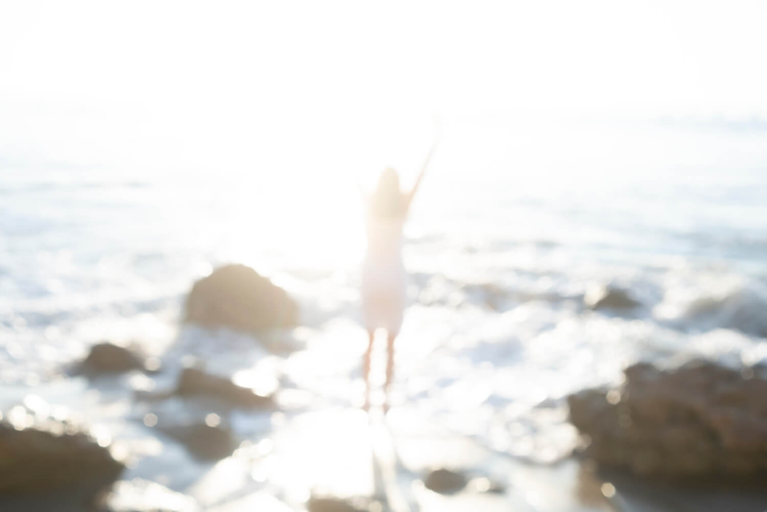 Melissa smilow, jumping for joy on the beach, who offers an intuitive healing journey program